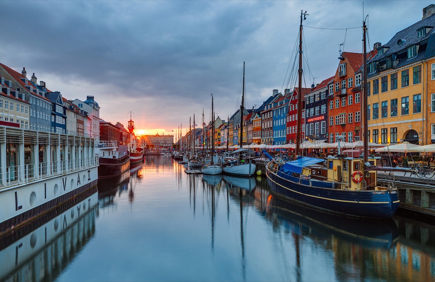 The coloured houses and boats of Nyhavn in Copenhagen at sunset